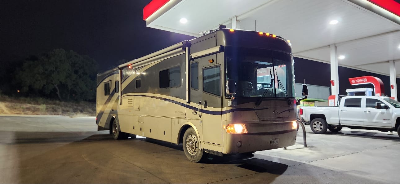 Class A motorhome fueling up after purchase