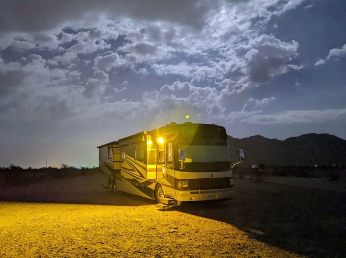 Class A motorhome under desert skies before pickup